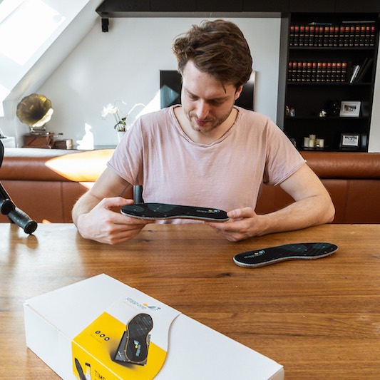 Patient holds sensor sole in his hands