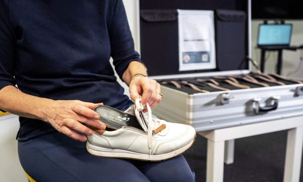 Woman uses stappone sensor sole in sport shoe